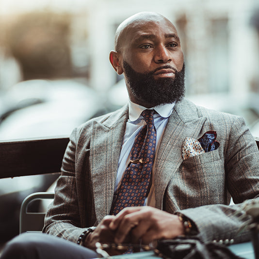 man in a suit, looking confident with his beard