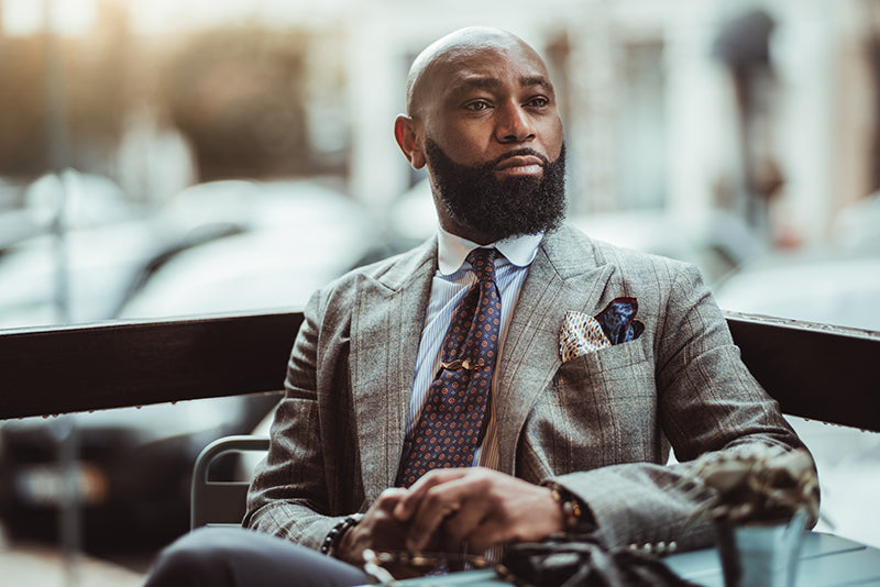 man in a suit, looking confident with his beard